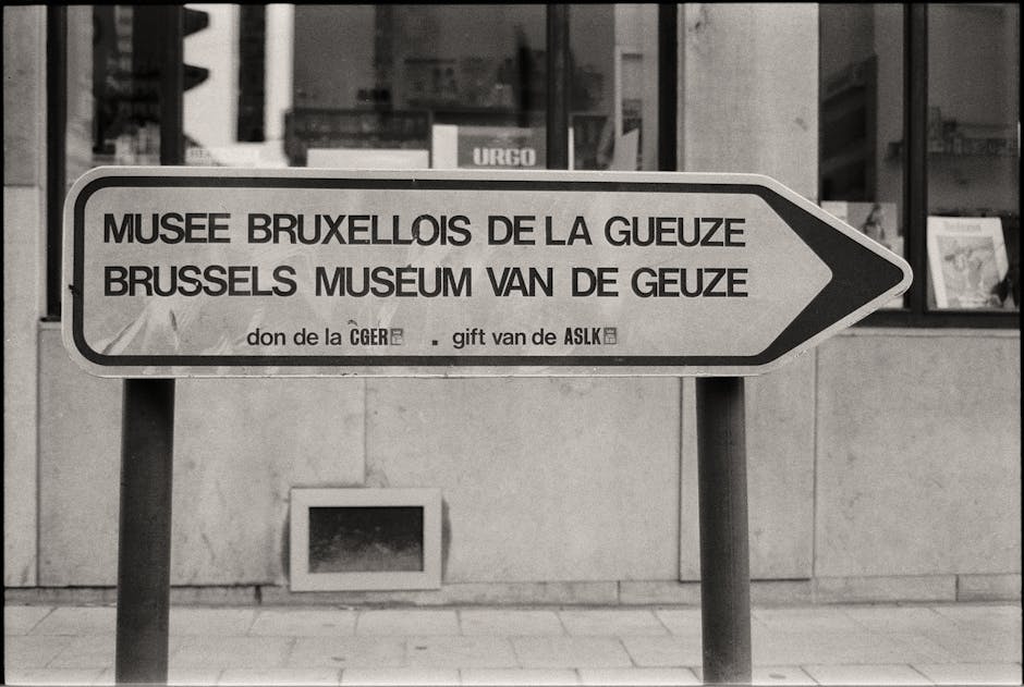 Black and white photo of a directional sign for the Brussels Museum of Gueuze.